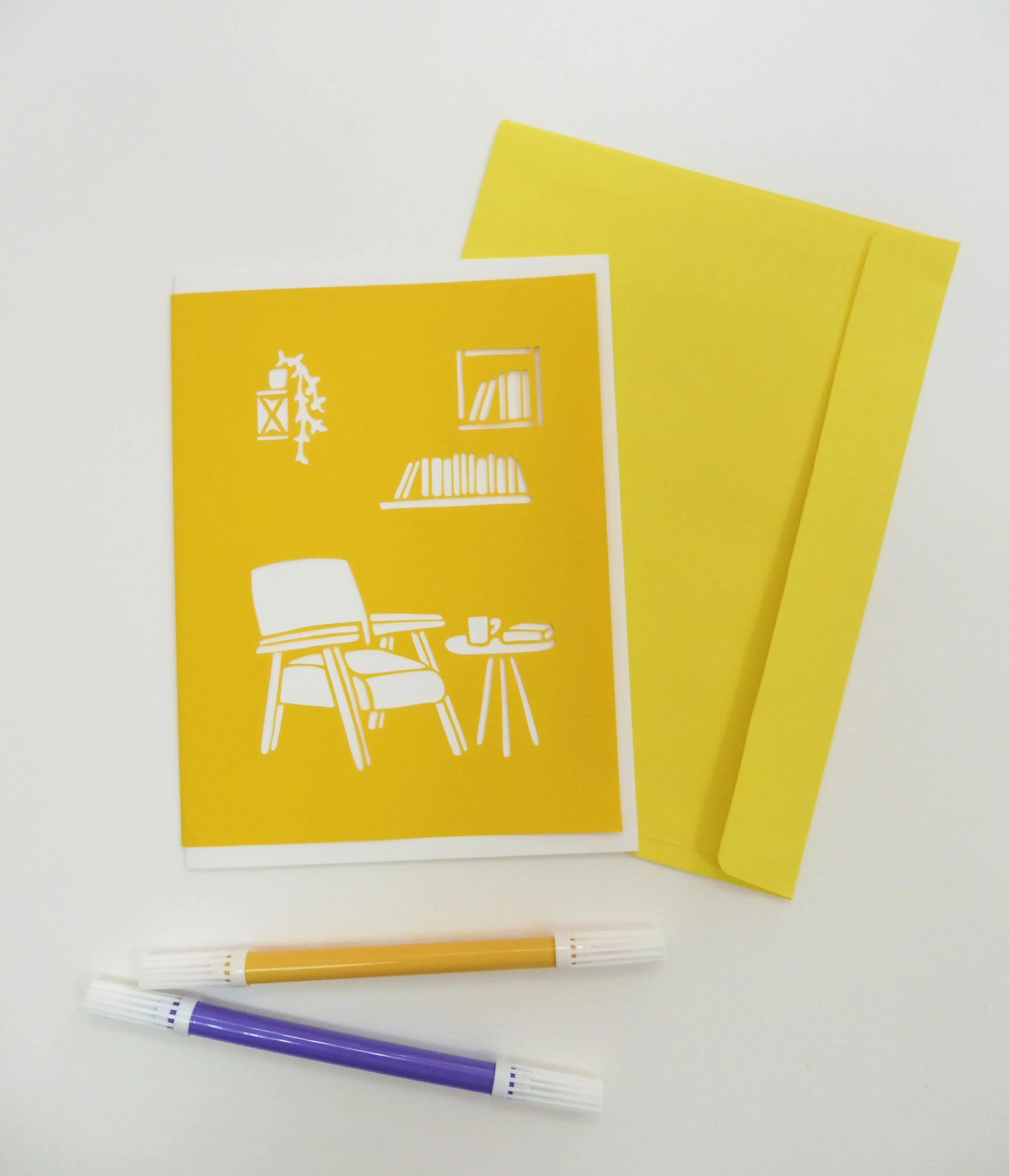 Die-cut postcard with living room and books design