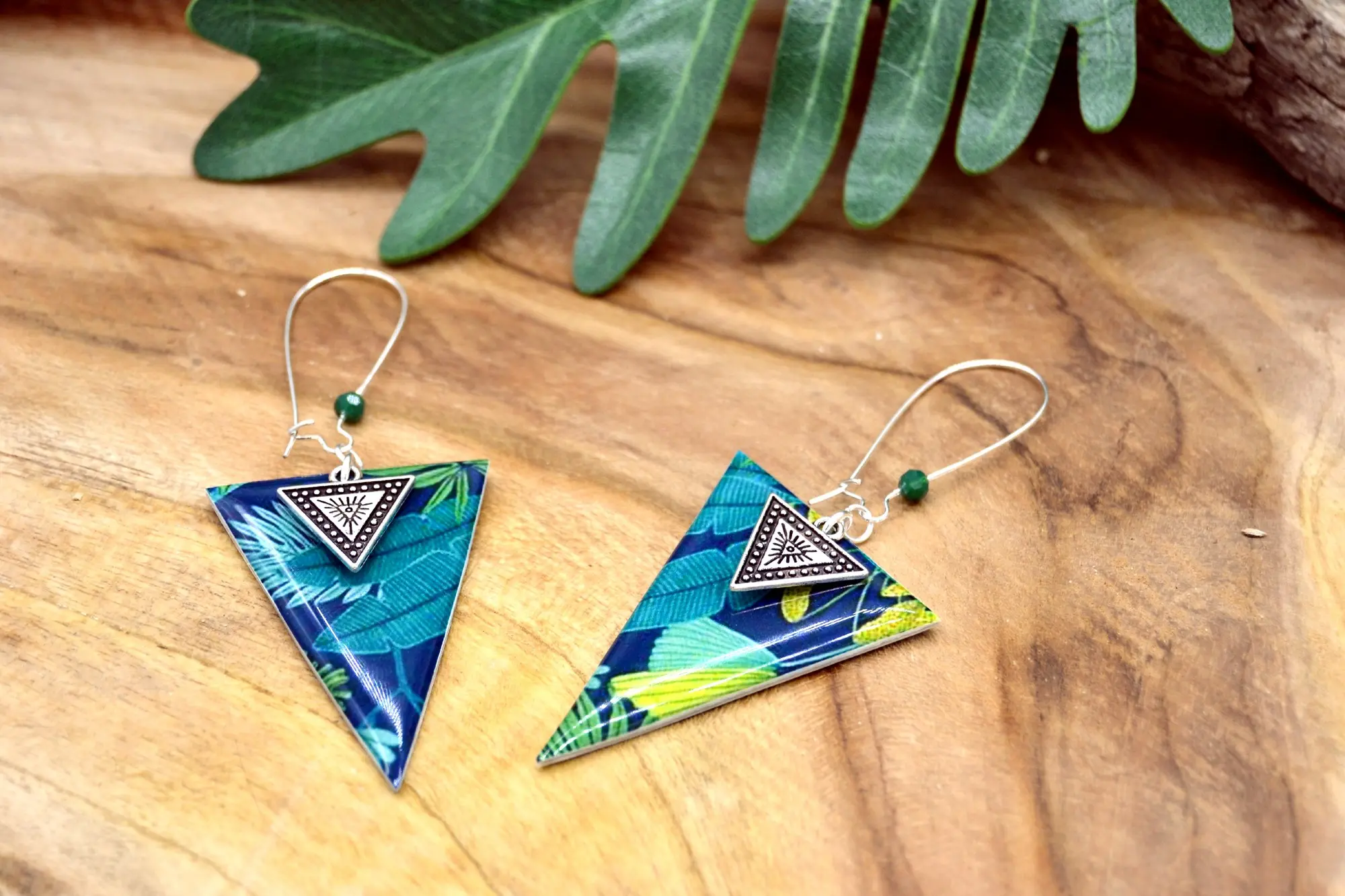Triangle earrings with green, blue and silver tropical leaf pattern