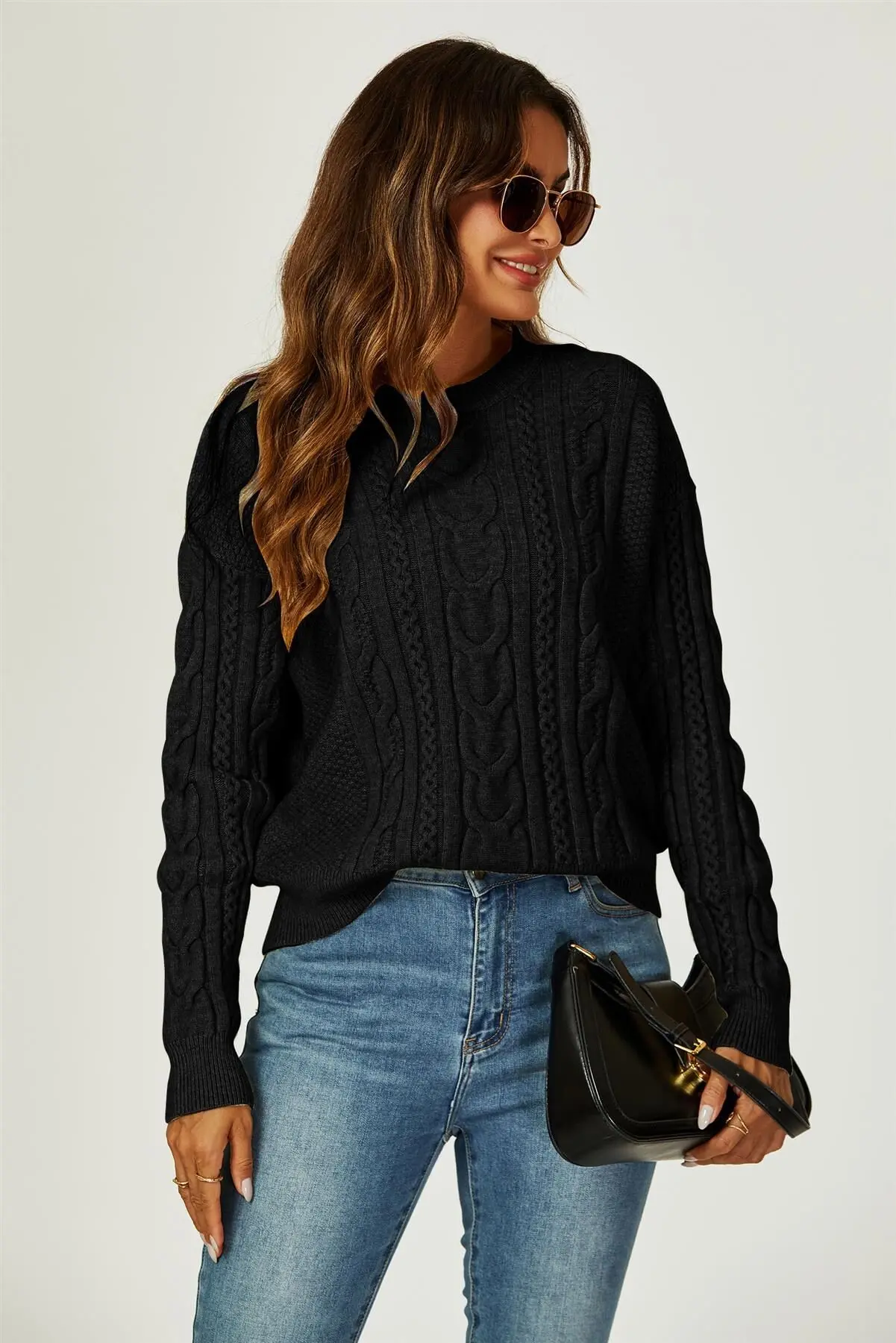 Black round neck sweater with cable pattern