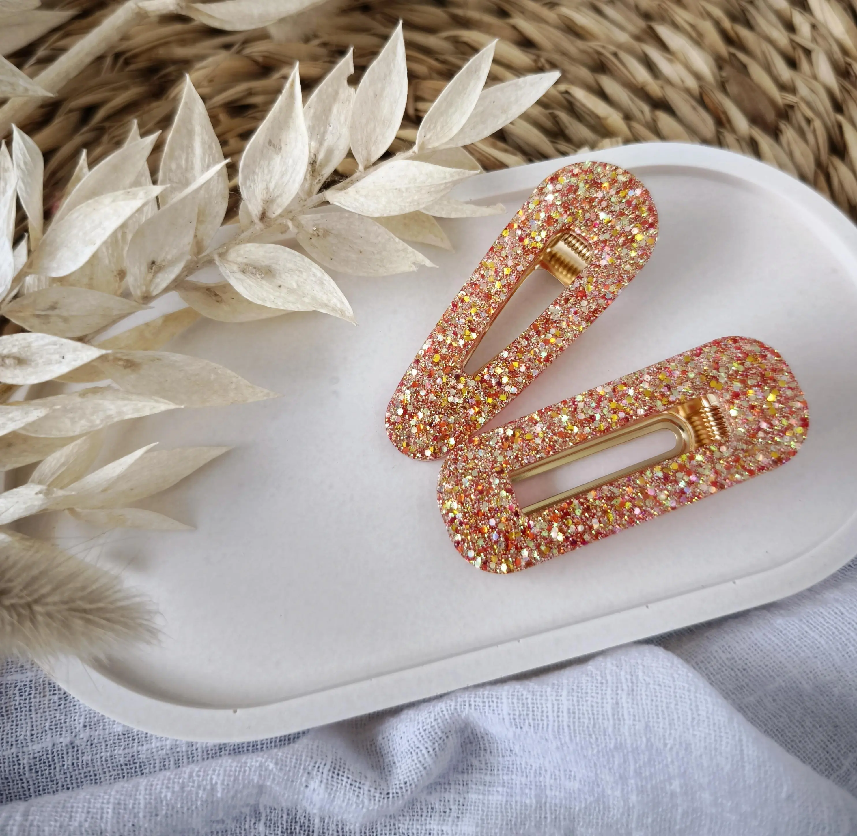 Red resin hair clip with shimmering highlights