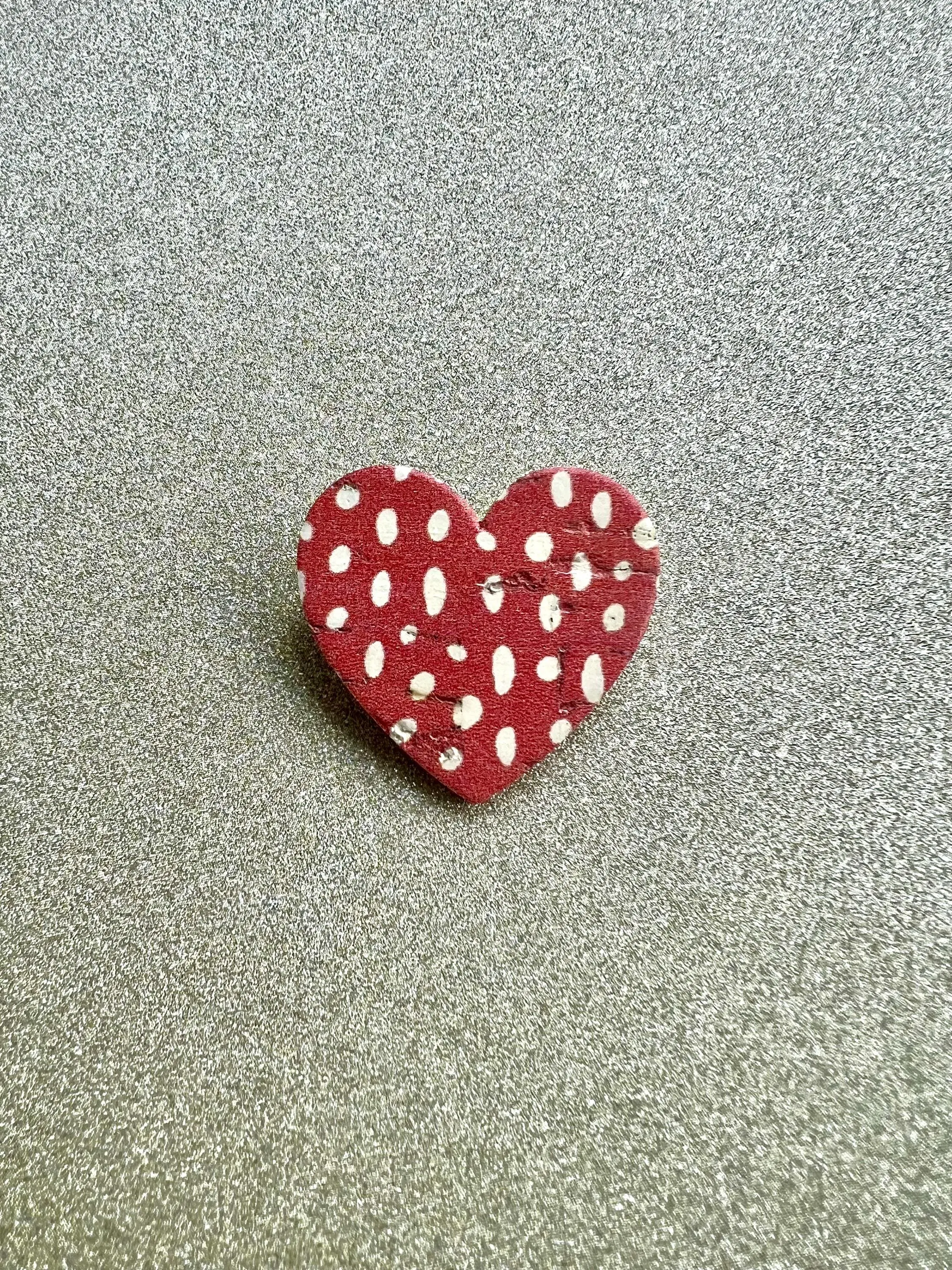 Heart brooch in cork and leather with white polka dots on a red background