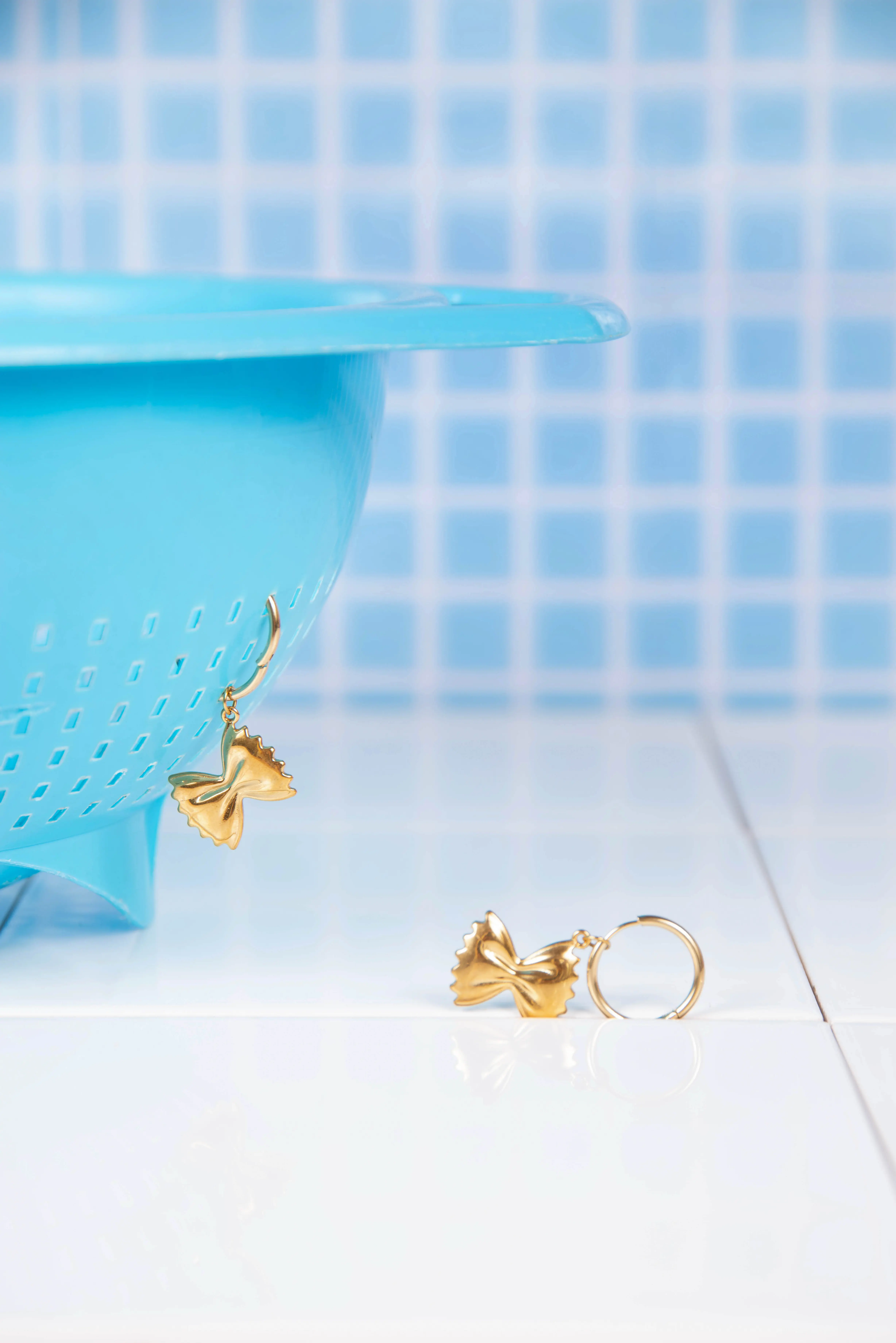 Stainless steel hoop earrings with farfalle charms
