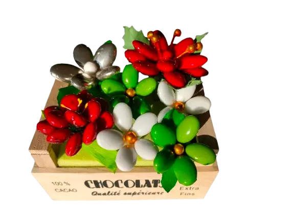 Christmas crate with flowers, sugared almonds, and chocolate