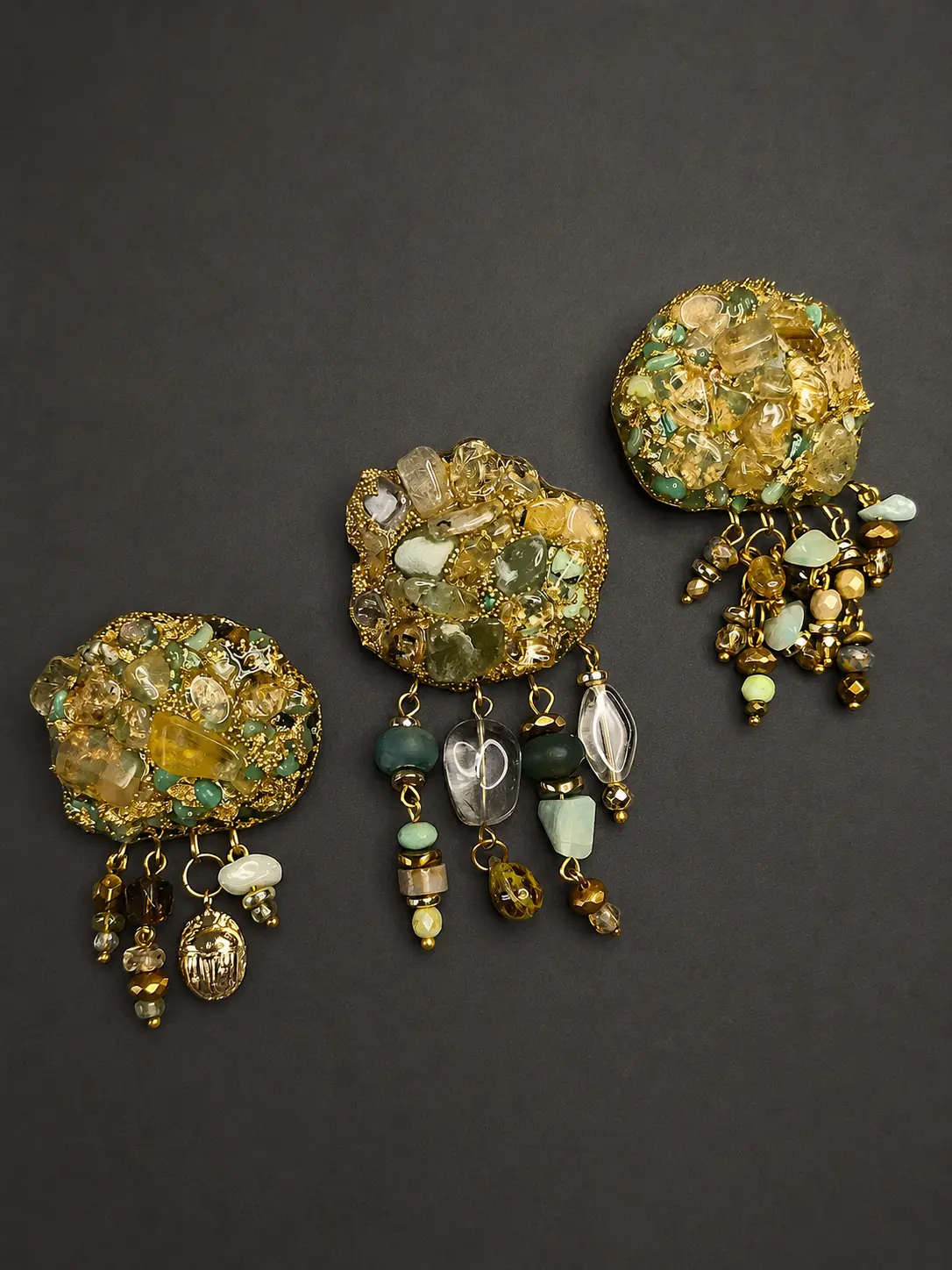 Set of three brooches with natural stones